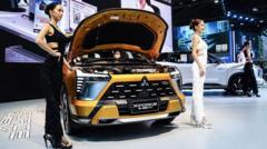 iPhone maker announces plan to build Mitsubishi EVs